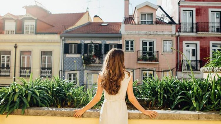 A girl looking something while standing