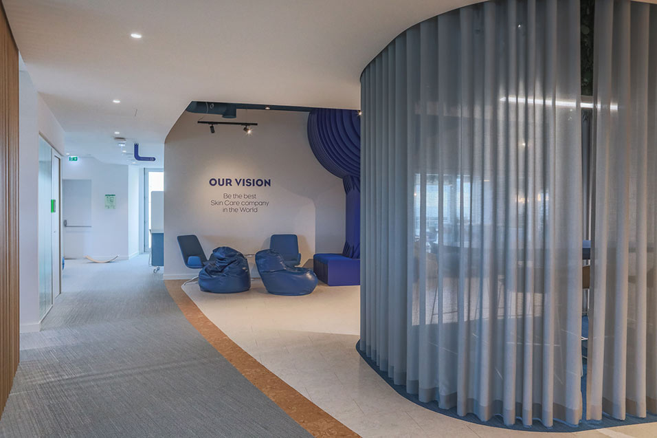 A modern office interior featuring blue furniture, creating a professional and inviting workspace atmosphere.