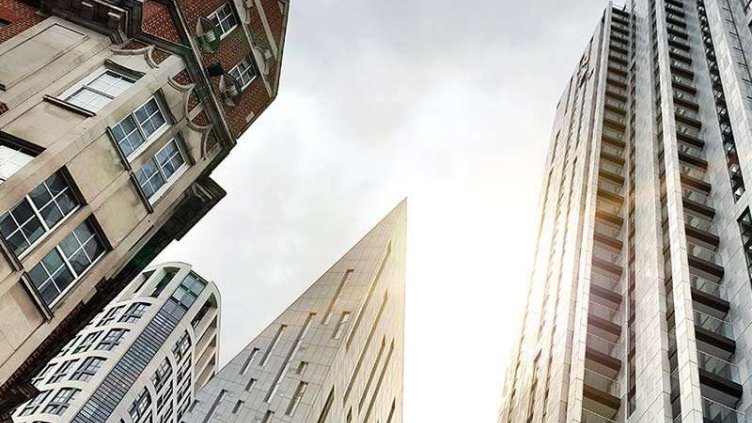 Contrast between old building and new glass and steel office towers in Old Street in London, England