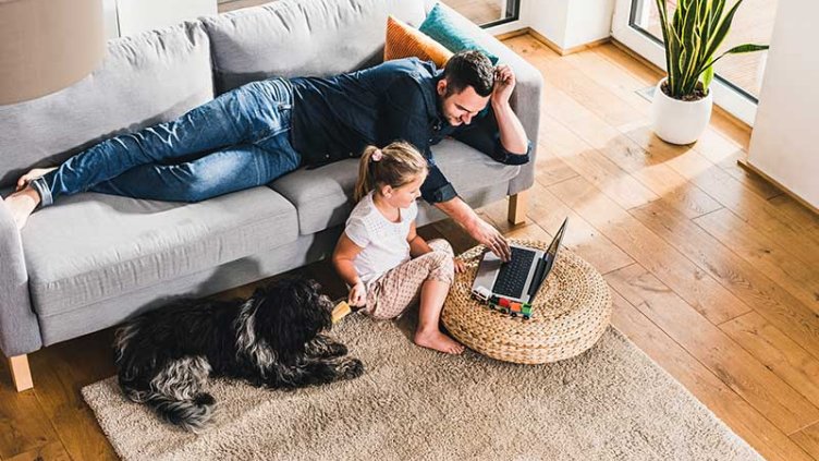 A father and child looking something in laptop