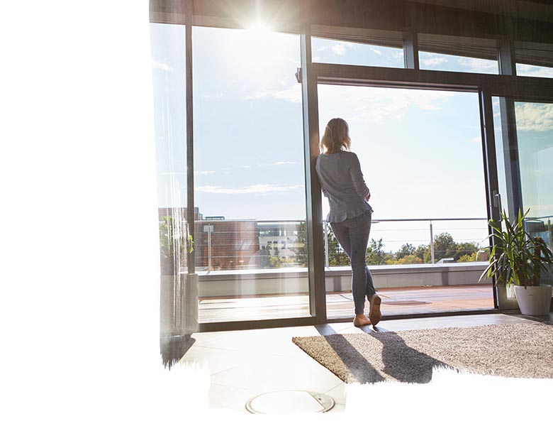 A woman standing and looking outside